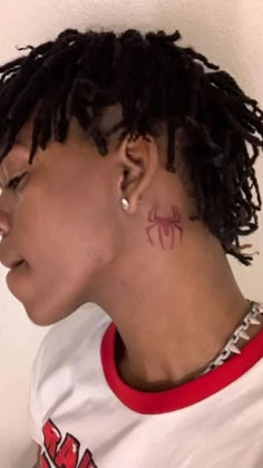 a close up of a person with a tattoo on their neck and behind her ear