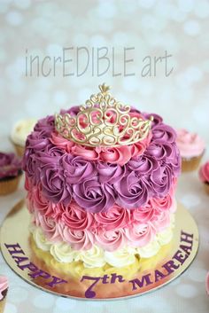 a birthday cake decorated with flowers and a crown on top is shown in this image