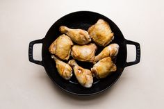 chicken wings in a cast iron skillet ready to be cooked