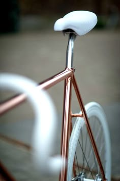 a close up of a bike with a white seat