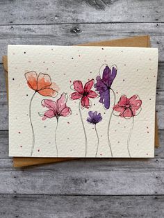 a card with watercolor flowers on it