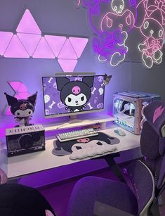 a computer desk topped with a monitor and keyboard next to a purple light filled wall