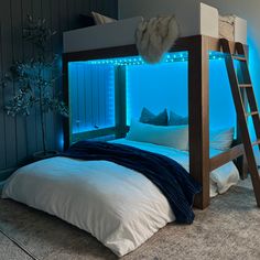 there is a bunk bed with blue lights in the corner and pillows on the bottom