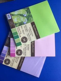 several different colored papers stacked on top of each other with the same color paper in front of them