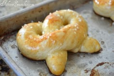 two doughnuts sitting on top of a baking pan