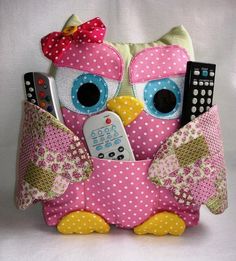 a stuffed owl with remote controls in it's pocket