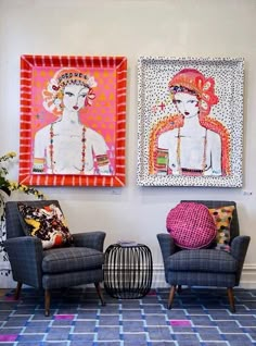 two paintings hang on the wall above chairs in a living room with patterned rugs