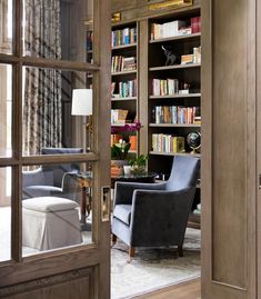 a living room filled with furniture and bookshelves