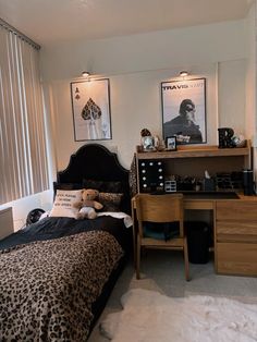 a bedroom with a leopard print comforter and desk