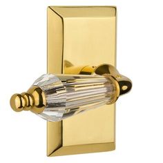 a gold plated wall light with crystal glass bulb