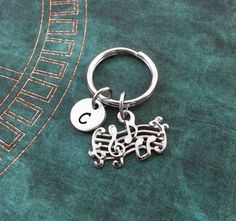 a silver keychain with musical notes on it