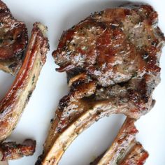 three pieces of meat sitting on top of a white plate