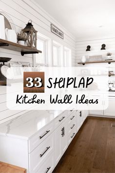 a kitchen with white cabinets and wood flooring that has the words 33 steppap kitchen wall ideas on it