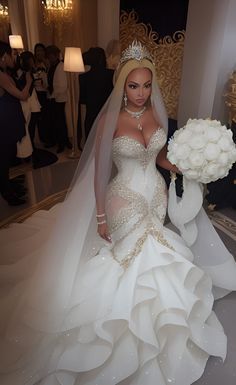 a woman in a wedding dress holding a bouquet and standing next to a large mirror