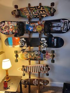 there are many skateboards mounted to the wall in this room, and one is upside down