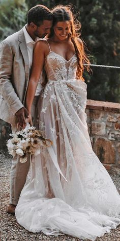 a man and woman in wedding attire standing next to each other