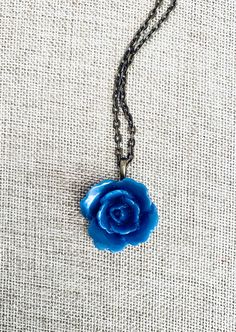 "A romantic dusty blue colored  flower cabachon pendant adorns this perfect little necklace! On an antique bronze chain *necklace measures 18\" *flower measures approximately 1\"" Cheap Handmade Blue Flower Necklace, Blue Rose Necklace, Blue Flower Necklace, Bronze Chain Necklace, Romantic Necklace, Romantic Jewellery, Rose Necklace, Blue Rose, Flower Necklace