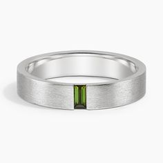 a white gold ring with a green tourmaline stone in the center and a thin band