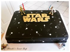 a star wars themed cake with two figurines on top