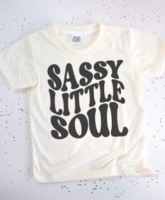 This sassy little soul kids t-shirt is made of 100% polyester, making it lightweight and breathable, perfect for active play. The material also helps keep colors bright, so your little one will always be looking stylish. *All tee brands run true to size. The graphic used on our tees are sublimation prints which means its printed into the fabrics on the shirt. No more peeling! *Care Instructions: Turn inside out & wash in cold. Lay Flat to dry. Do Not Iron. Sassy Graphic Tees, Toddler Girl Shirt Ideas, Basic T-shirt For Summer Playtime, Casual Tops With Custom Print For Playtime, Trendy White T-shirt For Playwear, Trendy Spring T-shirt For Playtime, Trendy Letter Print Tops For Playtime, Graphic Print T-shirt For Playtime, Casual T-shirt With Custom Print For Playtime