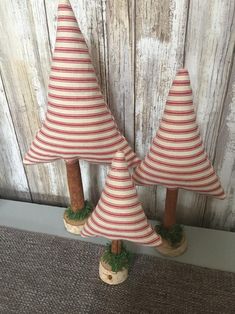 two red and white striped christmas trees on wooden sticks