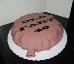 a cake with the words old far 40 on it is sitting on a black table