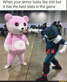 a person in a pink bear costume standing next to another person