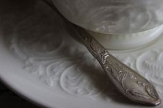 a spoon sitting on top of a white plate