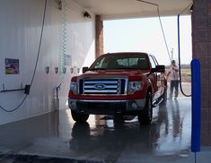 a red truck is parked in a garage