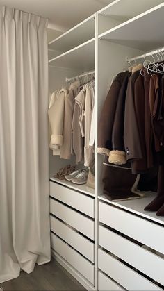 the closet is full of clothes and shoes