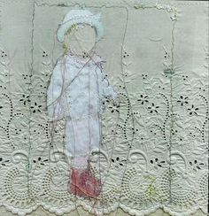 an embroidered piece of cloth with a small doll on it's chest and legs