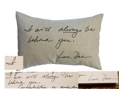 a pillow that has handwriting on it and is next to some papers with writing on them