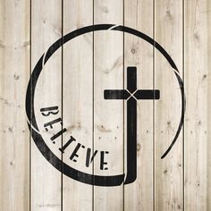 a wooden wall with a cross and the words be yewe written in black on it