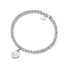 Inspired by the iconic key ring first introduced in 1969, the Return to Tiffany collection is a classic reinvented. An elegant bead bracelet and engraved tag combine to create a simple and timeless design.This item can be personalized. For more information, call 800 843 3269. Note, engraved items will be delivered after Christmas. Sterling silver; Size extra small; 6.25" long; Beads, 4 mm | Return to Tiffany® Heart Tag Bead Bracelet in Silver, Size: 6.25 in. Tiffany Bead Bracelet, Tiffany And Co Bracelet, Tiffany Bracelets, Return To Tiffany, Bracelet In Silver, Bracelets Design, Bracelet Love, Estilo Boho Chic, Heart Tag