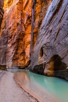 a narrow river in the middle of a canyon with water running between it's sides