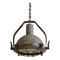 an old light fixture hanging from a chain on a white background with clippings