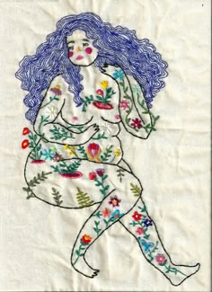 a woman with blue hair is sitting on a piece of white paper and has flowers all over her body