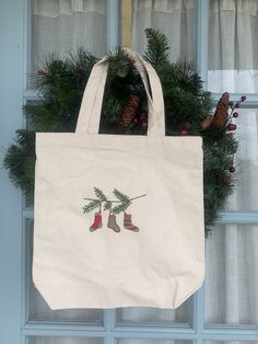 a white bag hanging from the side of a blue door with christmas decorations on it