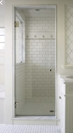 a white bathroom with a walk in shower