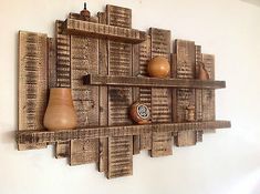 a wall mounted wooden shelf with books and pears on it