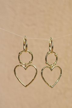 Heart You 14K Gold Plated Sterling Silver Earrings Attract love and light in our dazzling Heart You Hoops. These divine hoops are the perfect statement piece. Light weight and  earrings have a detachable pendant meaning you have two delicious earrings in one! Our jewels are here to make you feel empowered and radiant. * Detachable Charms * High quality 2 micron 14K gold plating to premium jewellery standards * Two Earrings in one * High quality Sterling Silver * Lead & Nickel free * Also availab Metal Heart Hoop Earrings With Heart Charm, Metal Heart Charm Dangle Hoop Earrings, Yellow Gold Dangle Hoop Earrings With Heart Charm, Gold Heart-shaped Hoop Earrings, Gold Heart-shaped Hoop Earrings For Valentine's Day, Printed Canvas Bag, Romantic Gifts For Her, Heart Hoop Earrings, Heart Dangle Earrings