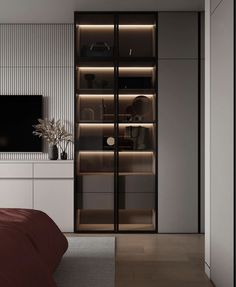 a bedroom with a bed, television and bookcase