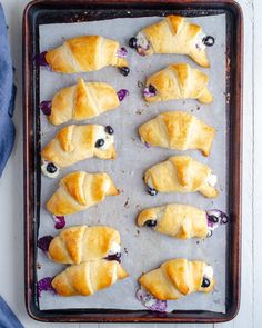 blueberry croissants on a baking sheet ready to be baked in the oven