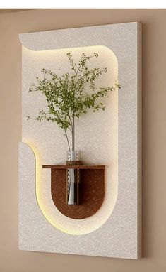 a vase with a plant in it is mounted on a wall