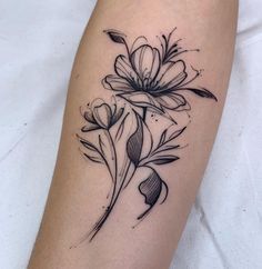 a black and white flower tattoo on the right arm, with leaves coming out of it