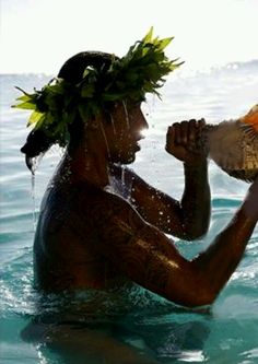 a man in the water with a bird on his shoulder and an orange headband