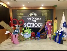 the welcome sign to school is decorated with cartoon characters