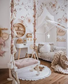 a bedroom with white furniture and pink flowers on the wall, including a canopy bed