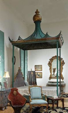 a canopy bed sitting in the middle of a room