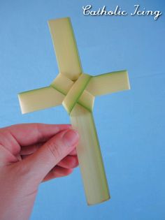 a person holding a plastic cross in their hand